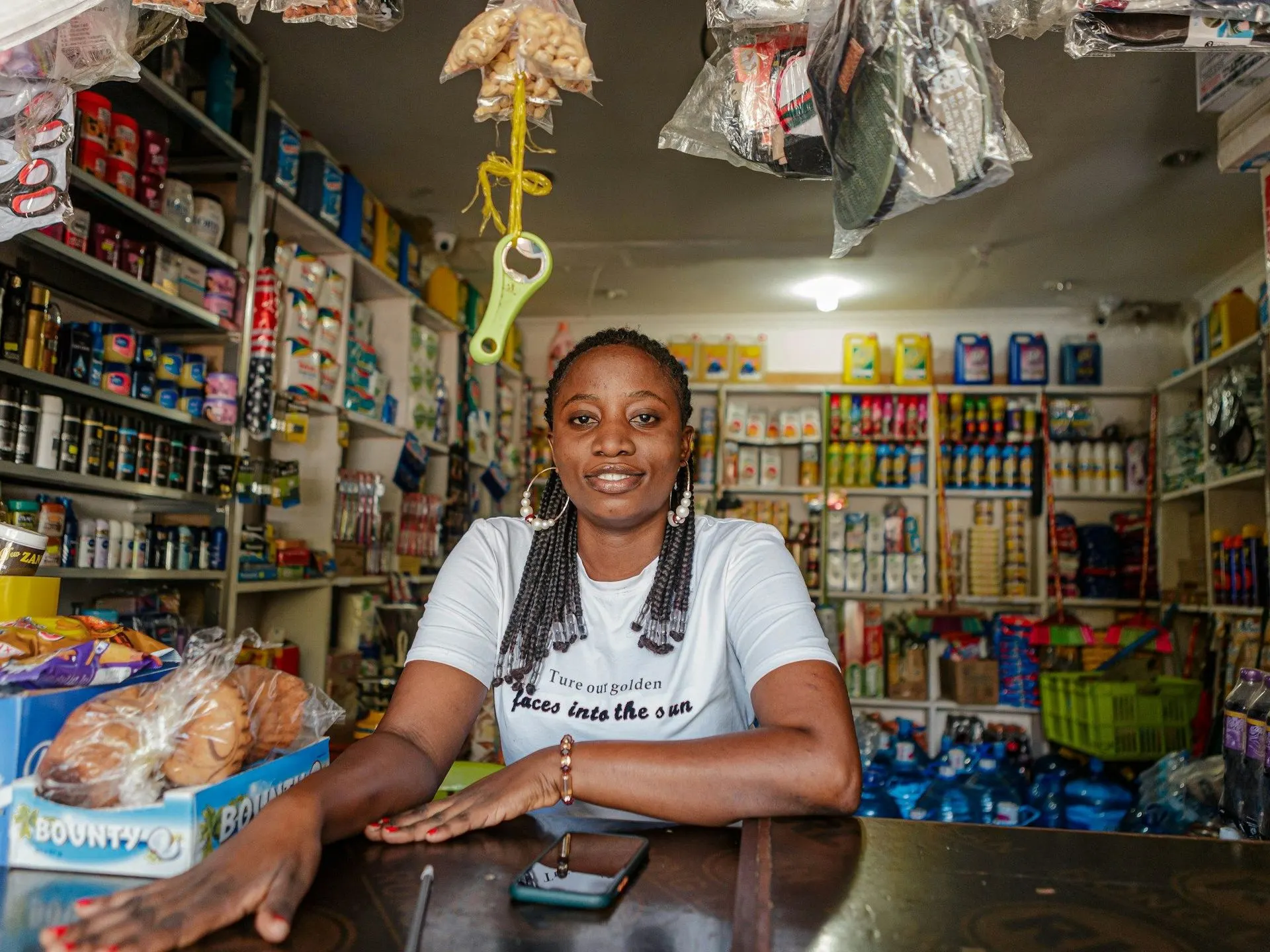Commerçante souriante au comptoir de sa boutique